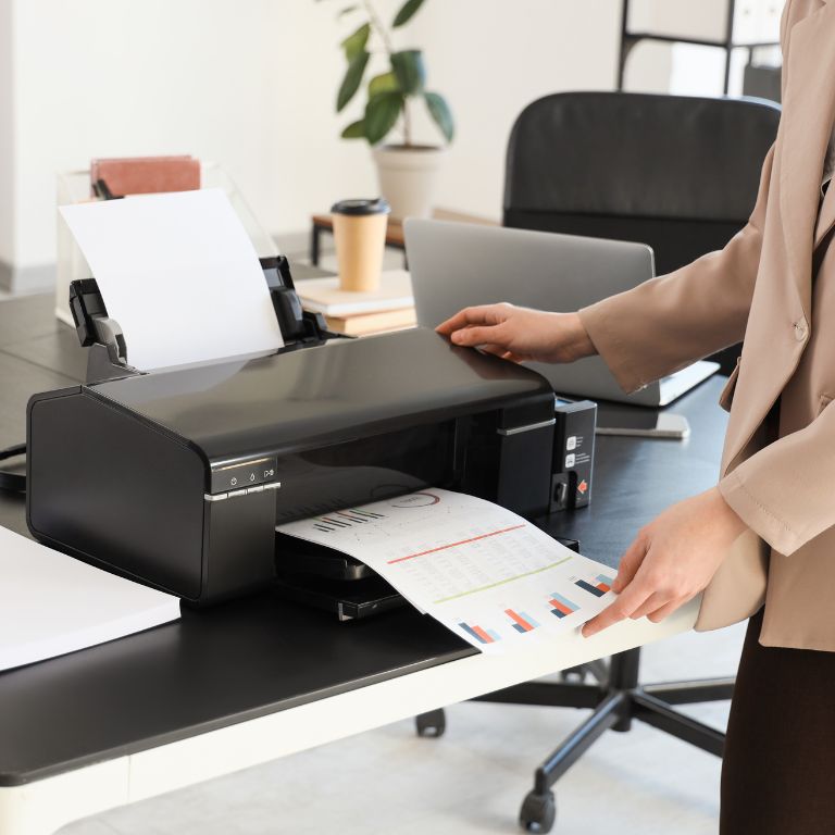 printer on table with office staff